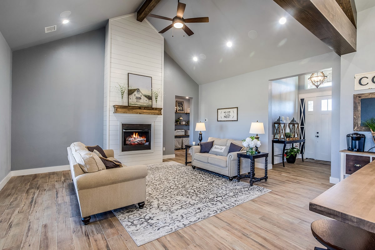 Living room with fireplace, seating and decor